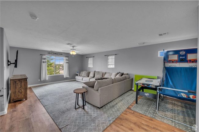 Living room featuring baseboards, wood finished floors, and visible vents | Image 29