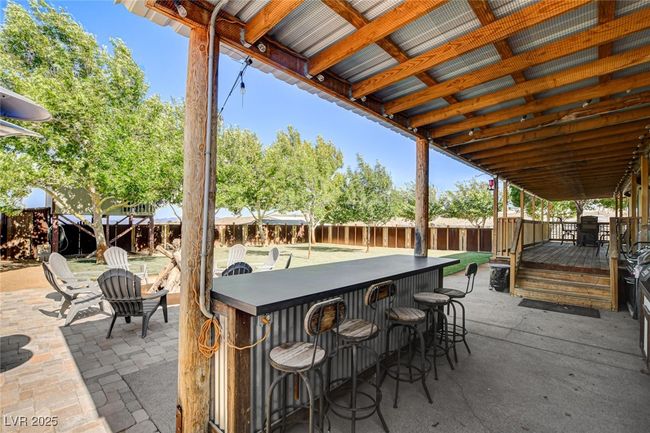 Fenced backyard with a wooden deck and a patio | Image 40