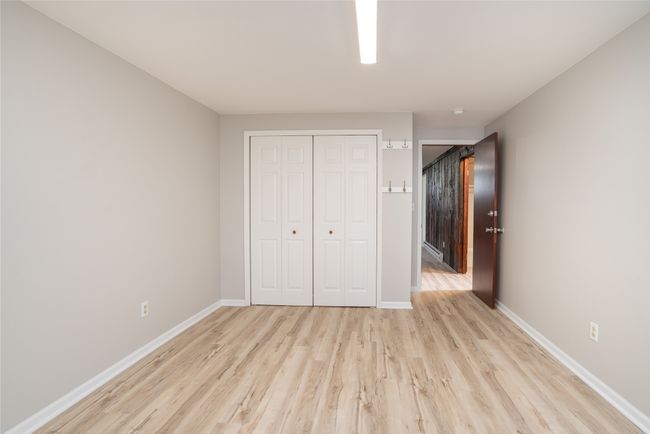 Unfurnished bedroom featuring light wood finished floors, baseboards, and a closet | Image 27