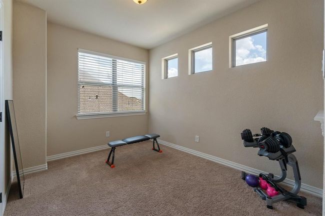 This area is used for workout equipment, but can be used as a second office, or quiet sitting area. | Image 34