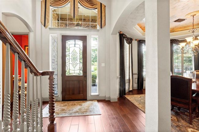 Light and bright entry with 8 ft solid wood front door and soaring ceilings. | Image 7