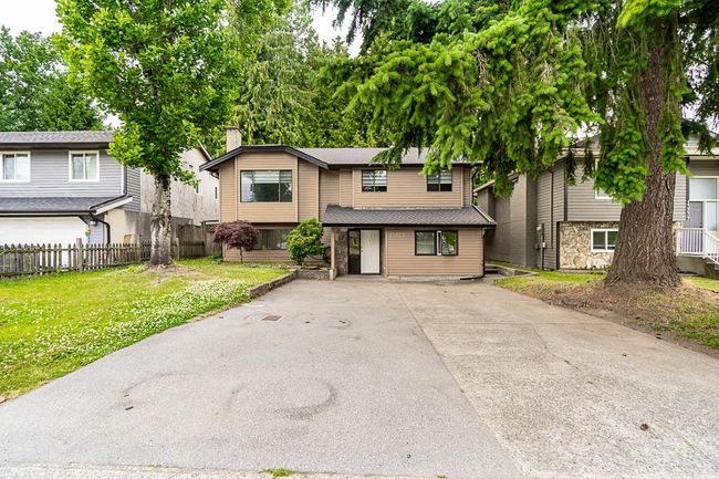 View of front of home featuring a chimney and driveway | Image 38