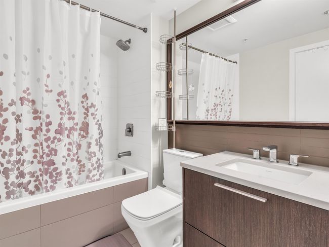 Full bath with visible vents, shower / bath combination with curtain, vanity, and toilet | Image 14