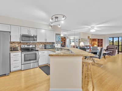 Open concept kitchen with stainless appliances, granite countertop, double sink, updated cabinets | Image 3