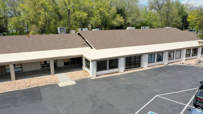 Back of property with roof with shingles, a patio area, and uncovered parking | Image 6
