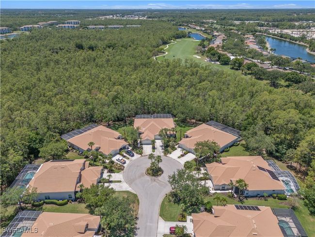 Aerial perspective of suburban area with a large body of water, a forest, and a golf course | Image 30
