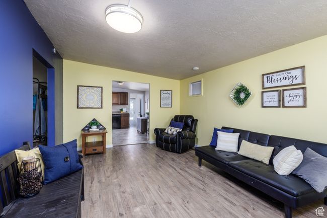 Living room featuring wood finished floors and a textured ceiling | Image 4