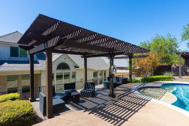 View of swimming pool with a pergola, a patio area, a fenced in pool, and fence | Image 24