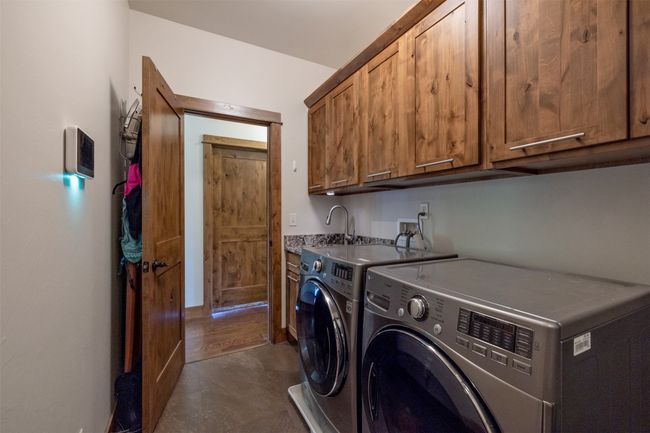 Washroom with cabinet space and independent washer and dryer | Image 27