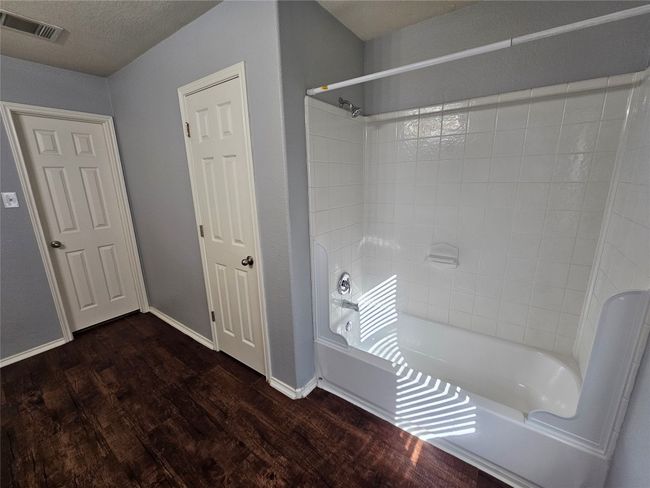 Bathroom with wood finished floors and tub / shower combination | Image 18