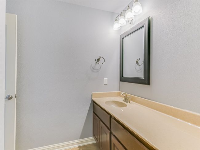 Upstairs bathroom features a long vanity. | Image 22