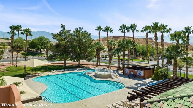 Community pool featuring a mountain view and a patio area | Image 71