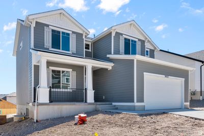 View of front of house featuring a garage and a porch | Image 2