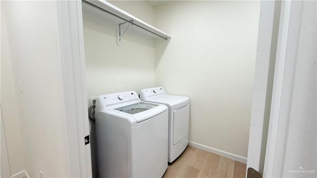 Laundry room with independent washer and dryer and light wood-style floors | Image 4