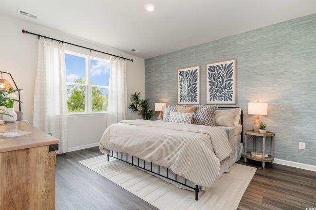 Bedroom with wallpapered walls, wood finished floors, and an accent wall | Image 12