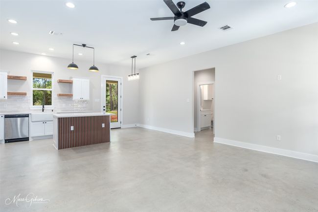 Unfurnished living room with recessed lighting, a ceiling fan, a sink, baseboards, and finished concrete floors | Image 6