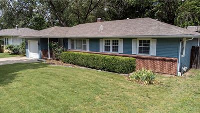 Ranch-style house with a garage and a front yard | Image 1