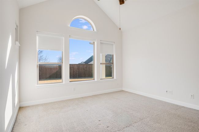 Spare room featuring carpet floors, high vaulted ceiling, and a ceiling fan | Image 19