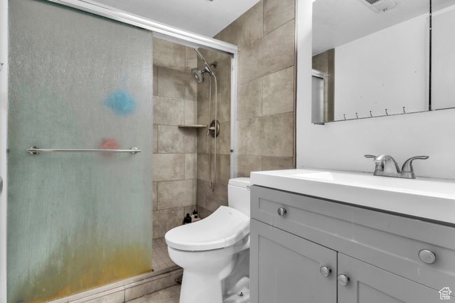 Bathroom featuring a stall shower and vanity | Image 23