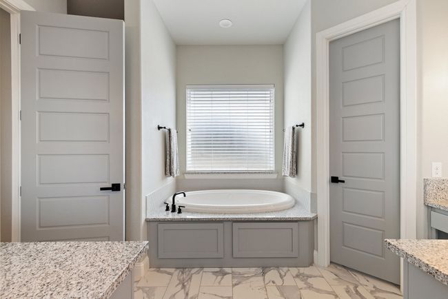 Bathroom featuring a bath, marble finish floor, and vanity | Image 18