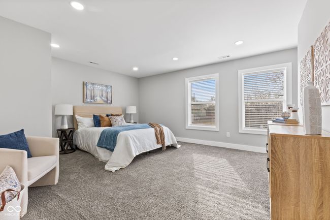 Primary bedroom with tons of natural light, baseboards, recessed lighting, visible vents, and carpet | Image 17