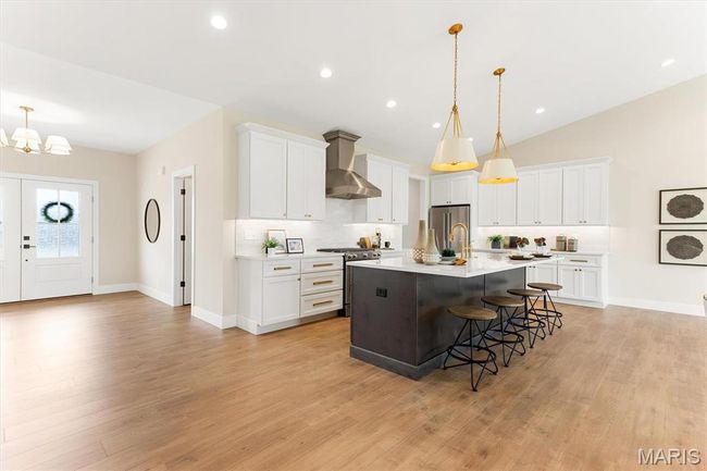Kitchen with oversized island, quartz countertops, stainless appliances and soft-close cabinetry! | Image 18