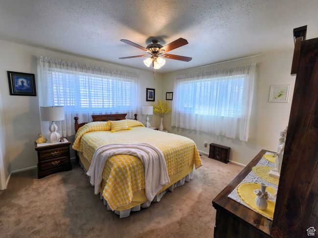 Carpeted bedroom with baseboards, ceiling fan, and a textured ceiling | Image 25