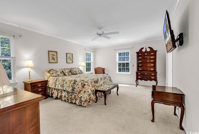 Bedroom with carpet, multiple windows, ornamental molding, and a ceiling fan | Image 8