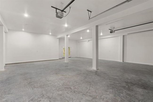 4 Car tandem garage with insulated walls, 11’ high ceilings, and french doors to patio | Image 33