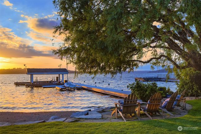 Moor your boat(s) on the 150 foot dock with 2 boat lifts and covered boat slip. Use your jet-ski from the dock or enjoy an evening gazing at the sunset by the firepit. | Image 34