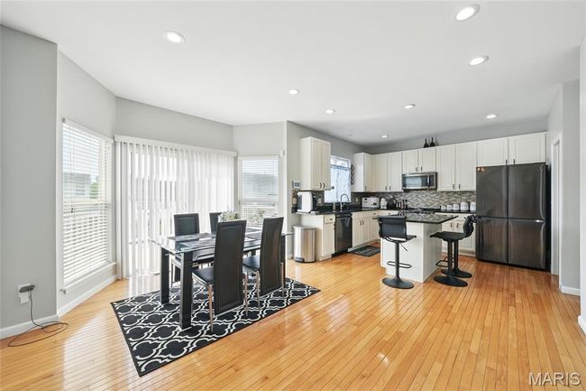 Dining room featuring light wood finished floors and recessed lighting | Image 14