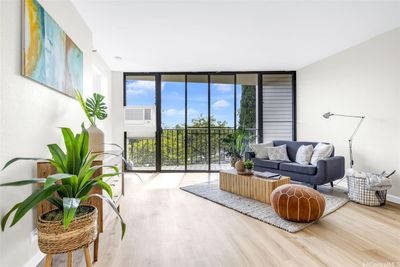 Enjoy this living room's privacy while looking out into lush greenery | Image 2