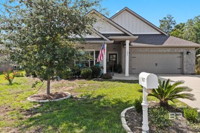 View of front of property featuring a garage and a front lawn | Image 1