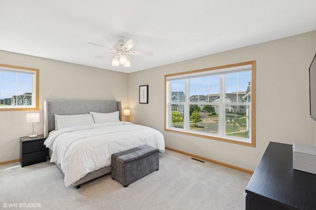 The primary bedroom features not one, but two windows—filling the space with natural light all day long | Image 26