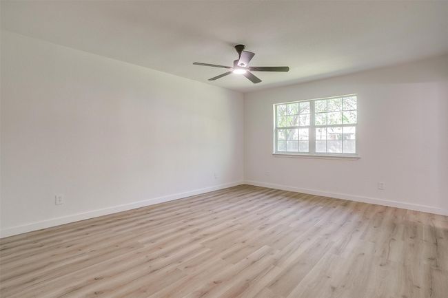 Empty room featuring light wood-type flooring and a ceiling fan | Image 21