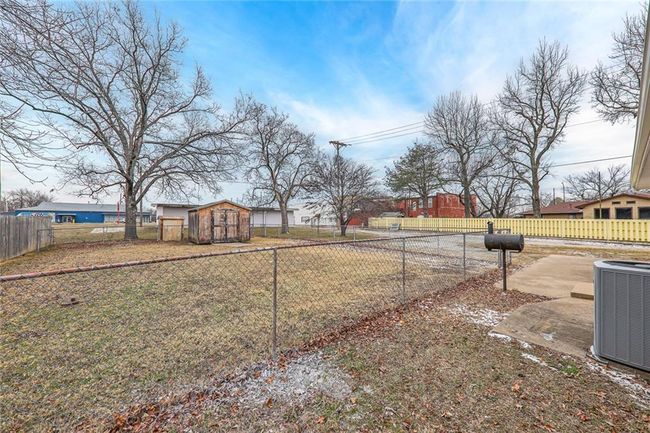 View of yard featuring a storage shed and central air condition unit | Image 18