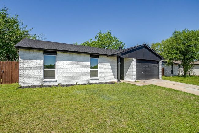 Mid-century home with an attached garage, brick siding, and concrete driveway | Image 26