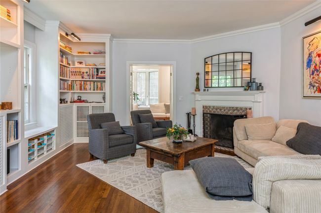 Wood burning fireplace surround is framed by hand crafted tiles. | Image 6