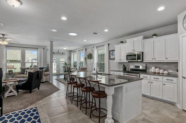 Kitchen with appliances with stainless steel finishes, recessed lighting, open floor plan, ceiling fan, and decorative backsplash | Image 5