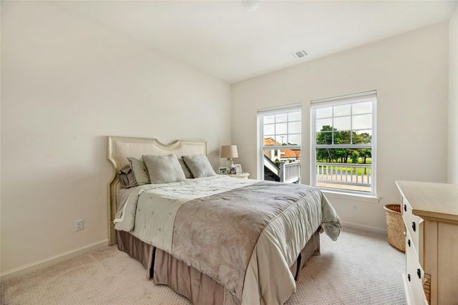 Bedroom with light colored carpet and baseboards | Image 12