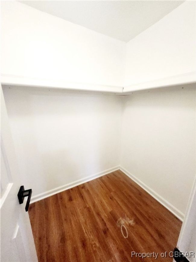 Walk in closet featuring hardwood / wood-style floors | Image 8