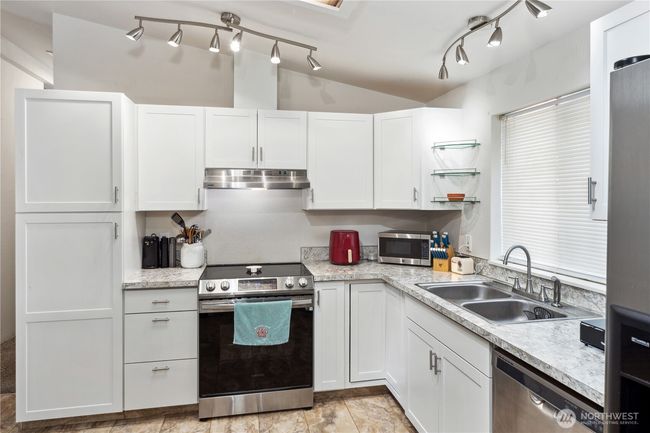 Skylight and window bring in a lot of natural light! Electric stove/oven is new | Image 10