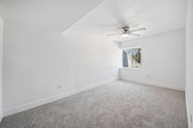 Unfurnished room with ceiling fan, carpet flooring, and baseboards | Image 20