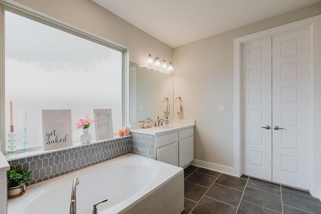 Primary bathroom with double doors to walk-in closet | Image 19