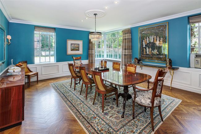 Dining space featuring crown molding, a chandelier, recessed lighting, plenty of natural light, and wainscoting | Image 4