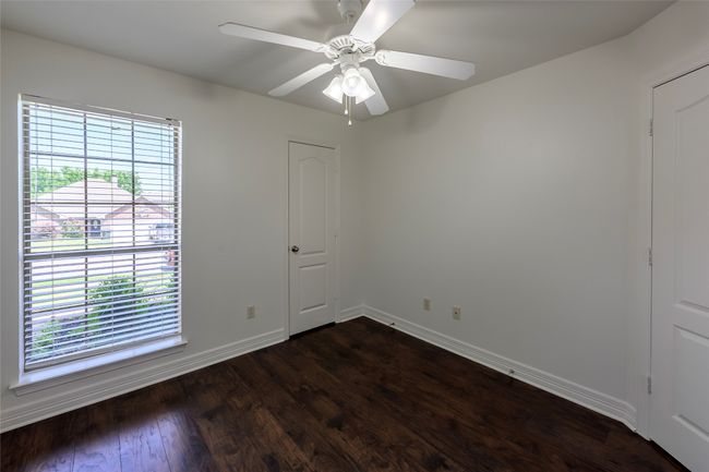 Spare room with baseboards, dark wood-style floors, and a healthy amount of sunlight | Image 33