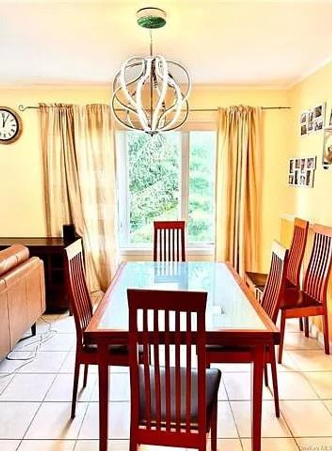 Dining room featuring a chandelier, plenty of natural light, and tile patterned flooring | Image 4