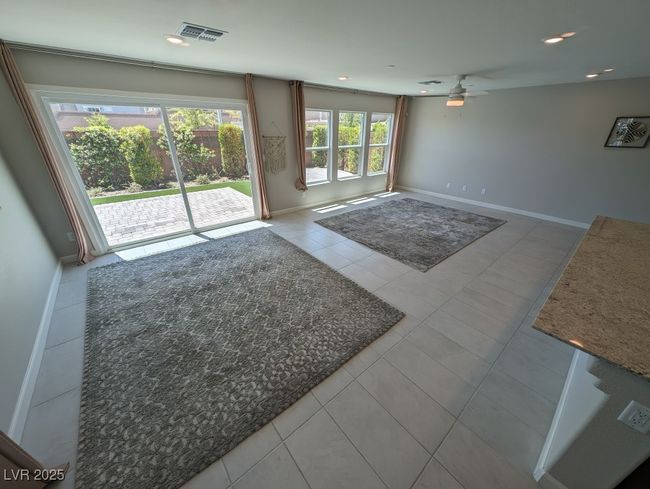 Unfurnished living room featuring tile patterned floors, ceiling fan, and recessed lighting | Image 6