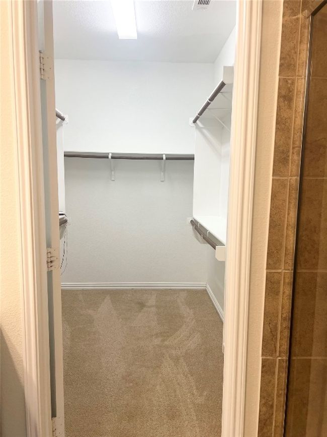 Walk in closet featuring carpet floors | Image 13