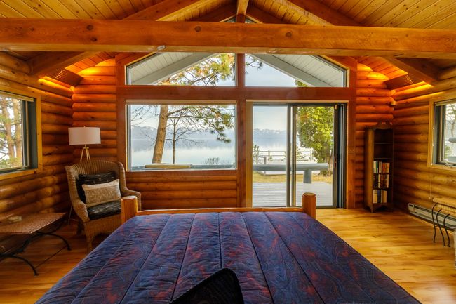 Bedroom with log walls and hardwood / wood-style flooring | Image 44